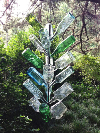 Photo: I’m especially fond of my hanging bottle tree. It’s up and out of the way. However, insects and spiders do get inside. The bottles had just been to the kitchen for their annual bath (hence the bubbles).